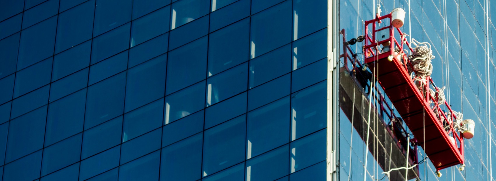 An All Window Cleaning Services worker works on a skyscraper that needed Illinois Window Cleaning Services